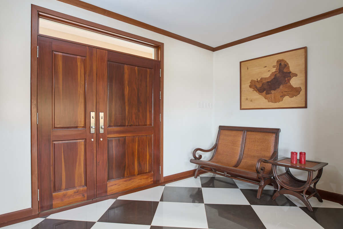 Cloak room with double-leaf door and inlaid wood map of Siquijor