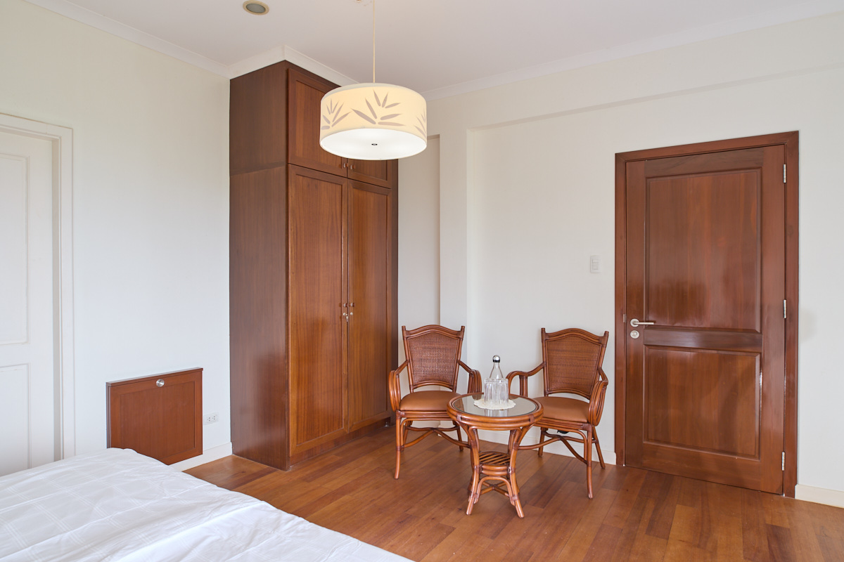 Upper-floor guest room with wardrobe and seating
