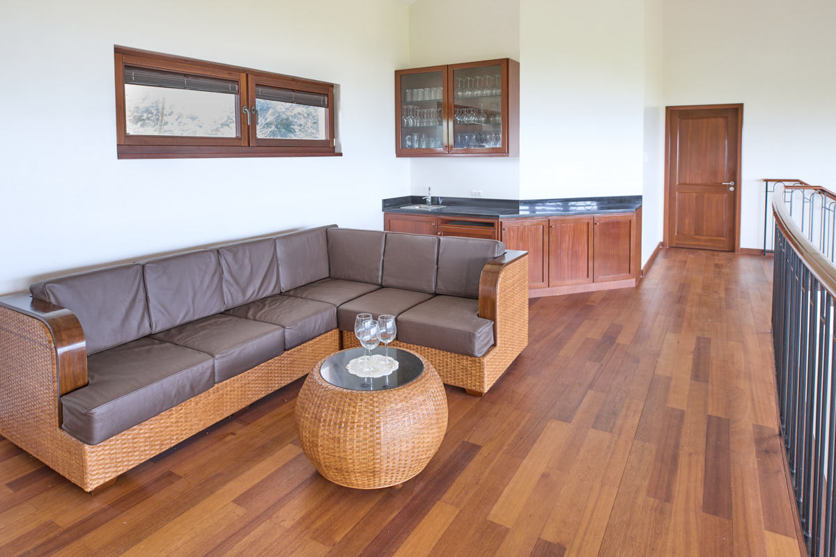 Upper lounge with leather corner sofa and bar