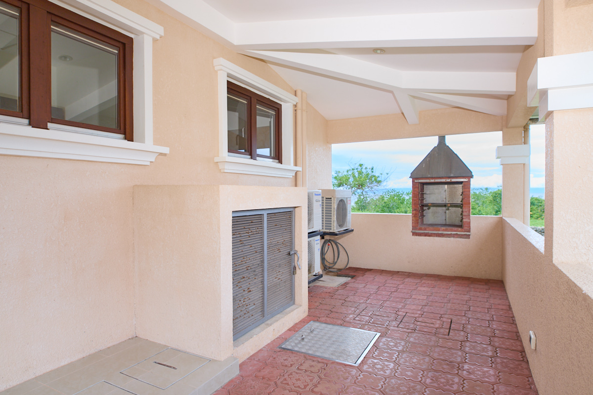 Covered utility area with two-sided outdoor grill
